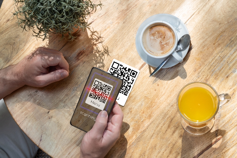 A smart phone scanning a QR Ordering code on a table
